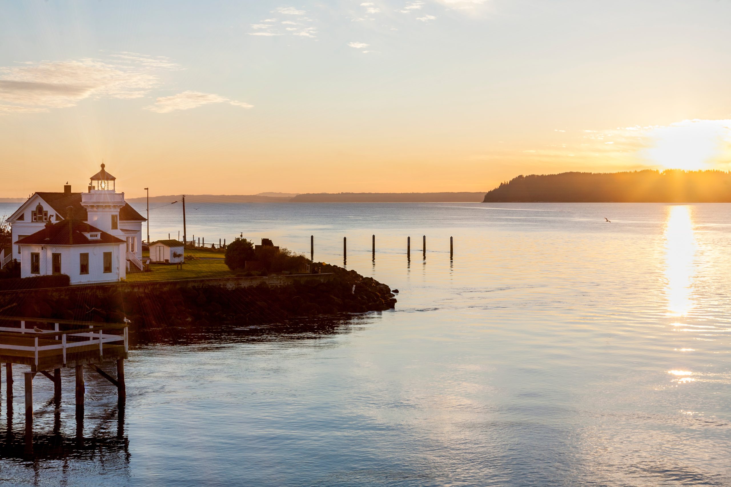 Sunset over Puget Sound and Mukilteo lighthouse with Whidbey Island in the distance
